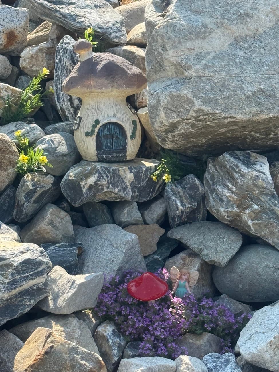 A fairy house and woodland friends tucked among the trees and rocks at Shuswap Kids Club