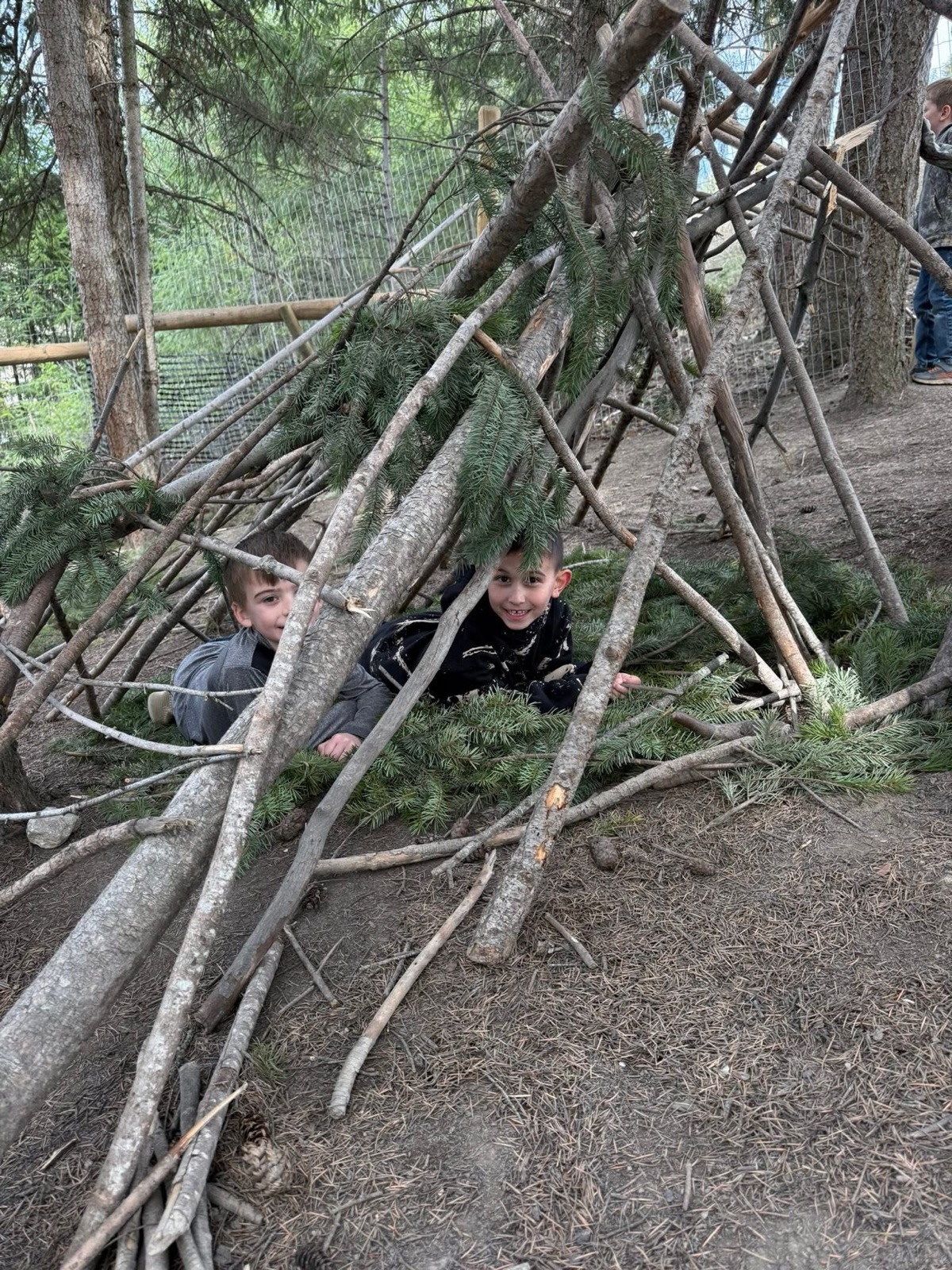 Children exploring the forest play space at Shuswap Kids Club